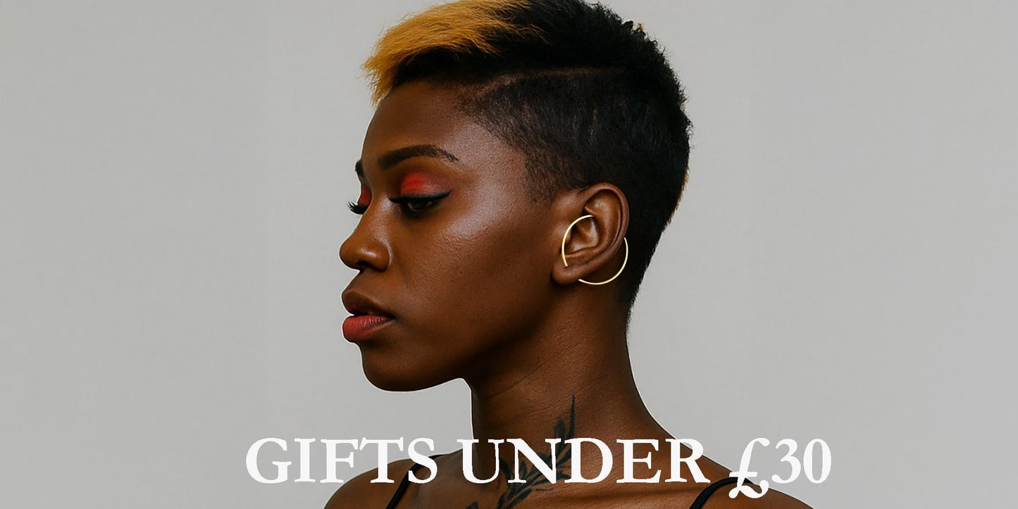 Model wearing minimalist gold hoop earrings from Otis Jaxon - featured in the Gifts Under £30 collection.